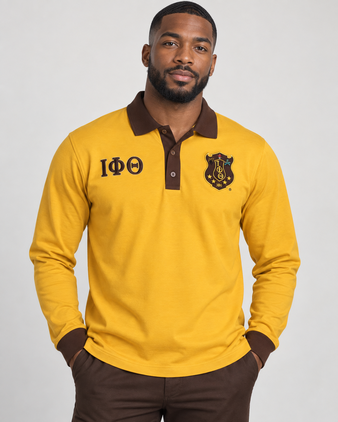 Iota Phi Theta gold and brown long-sleeve contrast polo with embroidered crest and Greek letters on male model