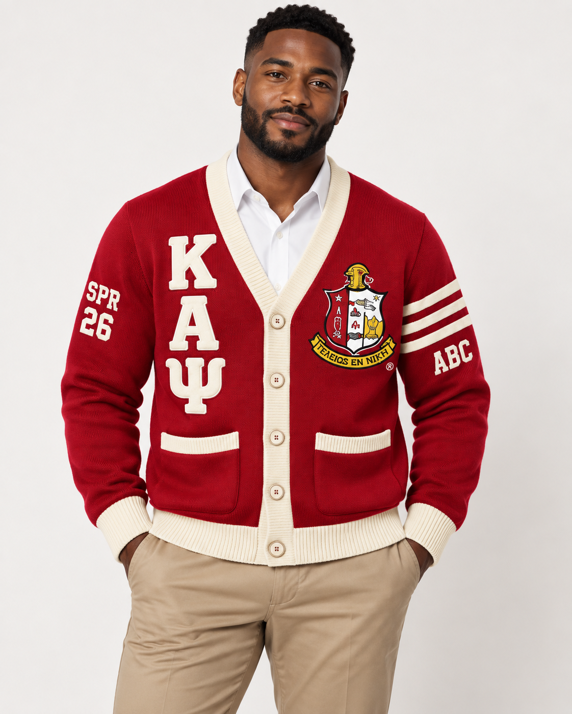 Black male model wearing Kappa Alpha Psi crimson and cream embroidered cardigan
