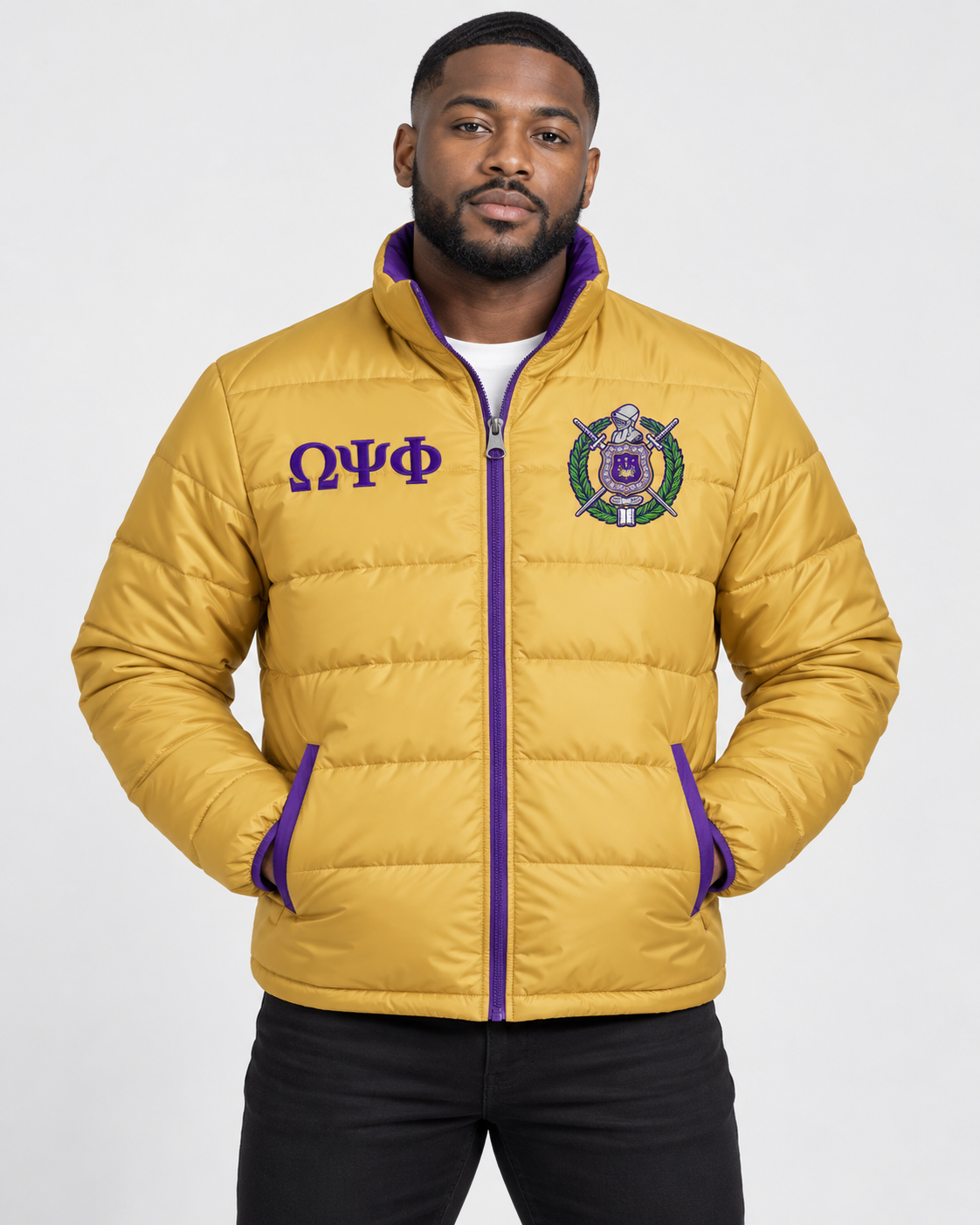 Omega Psi Phi old gold puffer jacket with purple trim and custom embroidery on male model