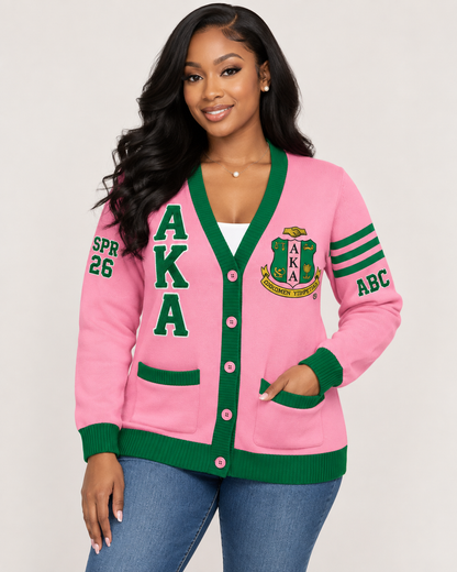 Black female model wearing Alpha Kappa Alpha pink and green embroidered cardigan