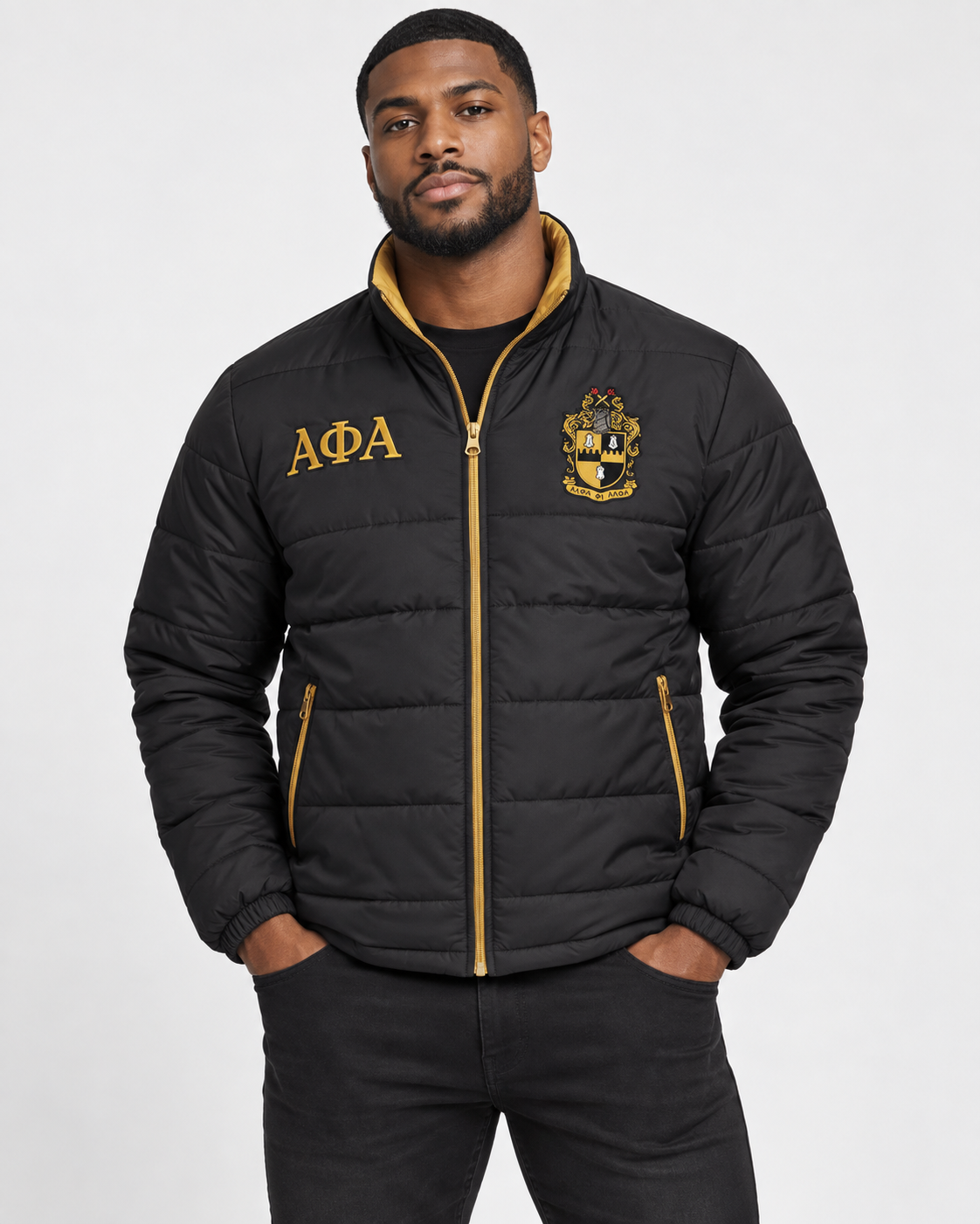 Alpha Phi Alpha black puffer jacket with old gold trim and custom embroidery on male model