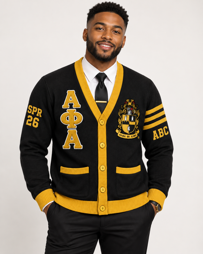 Black male model wearing Alpha Phi Alpha black and gold embroidered cardigan