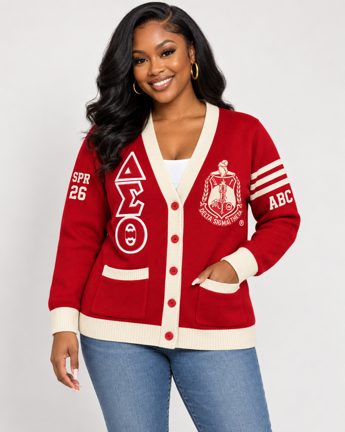 Black female model wearing Delta Sigma Theta crimson and cream embroidered cardigan