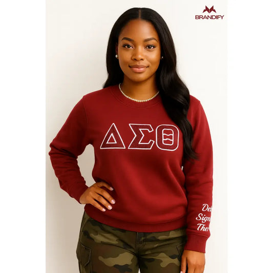 Model wearing a crimson Delta Sigma Theta sweatshirt with cream outlined ΔΣΘ chenille letters and sleeve detail