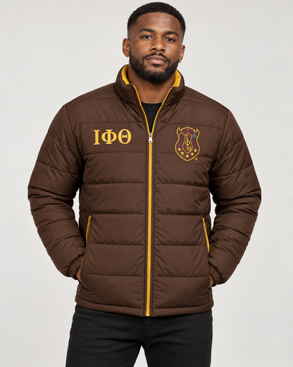 Iota Phi Theta brown puffer jacket with gold trim and custom embroidery on male model