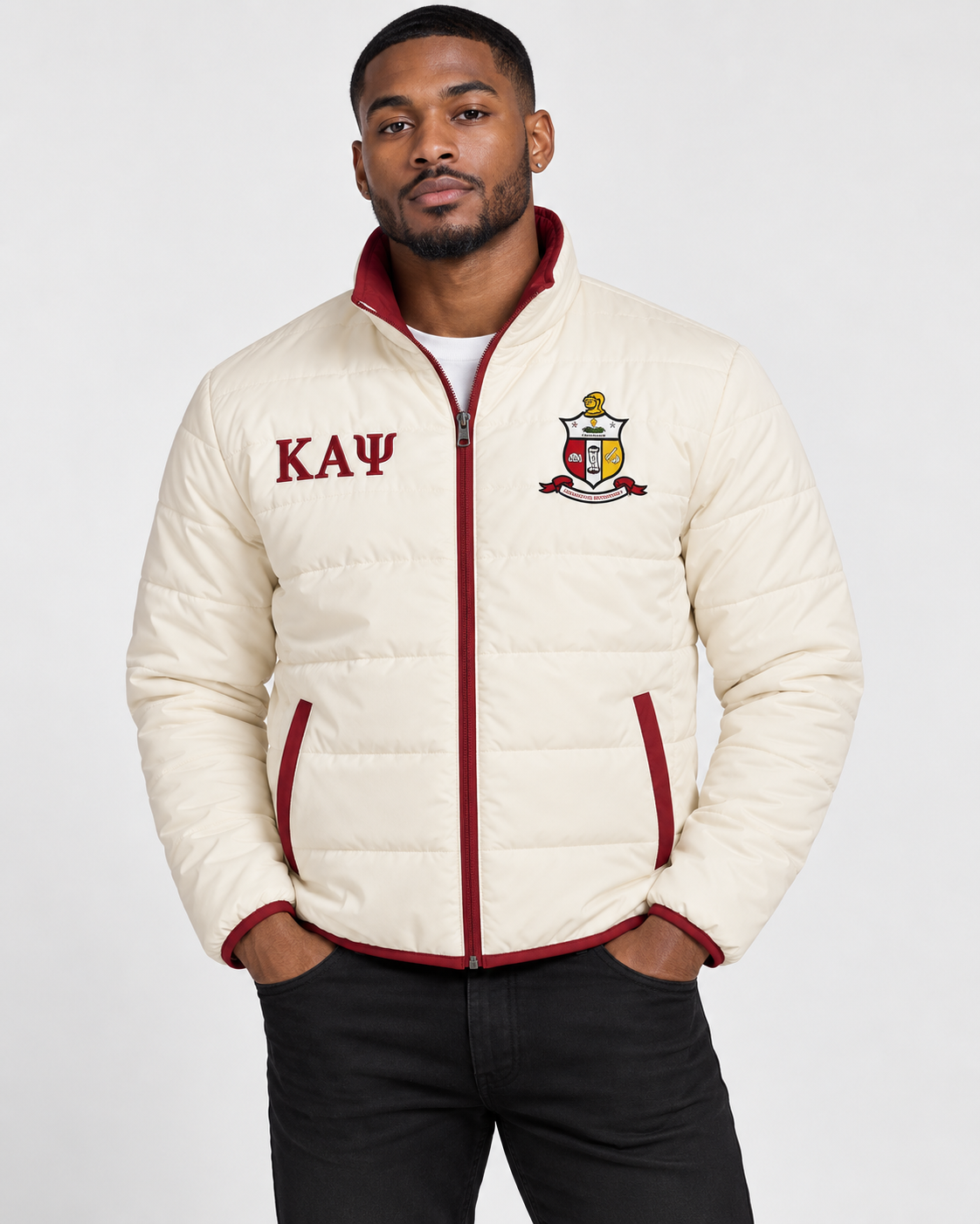 Kappa Alpha Psi cream puffer jacket with crimson trim and custom embroidery on male model