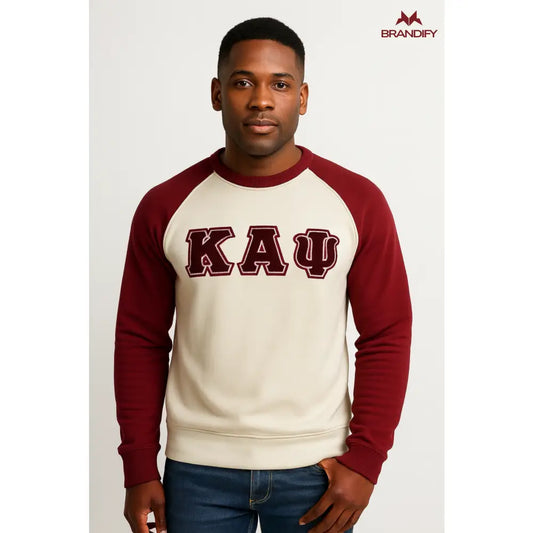 Man wearing a cream and crimson Kappa Alpha Psi ΚΑΨ raglan chenille sweatshirt