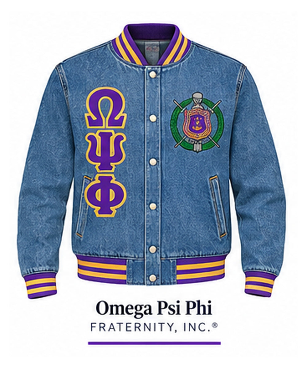 Medium-blue Omega Psi Phi full-denim varsity jacket with denim sleeves, purple and gold trim, crest, and stacked Greek letters