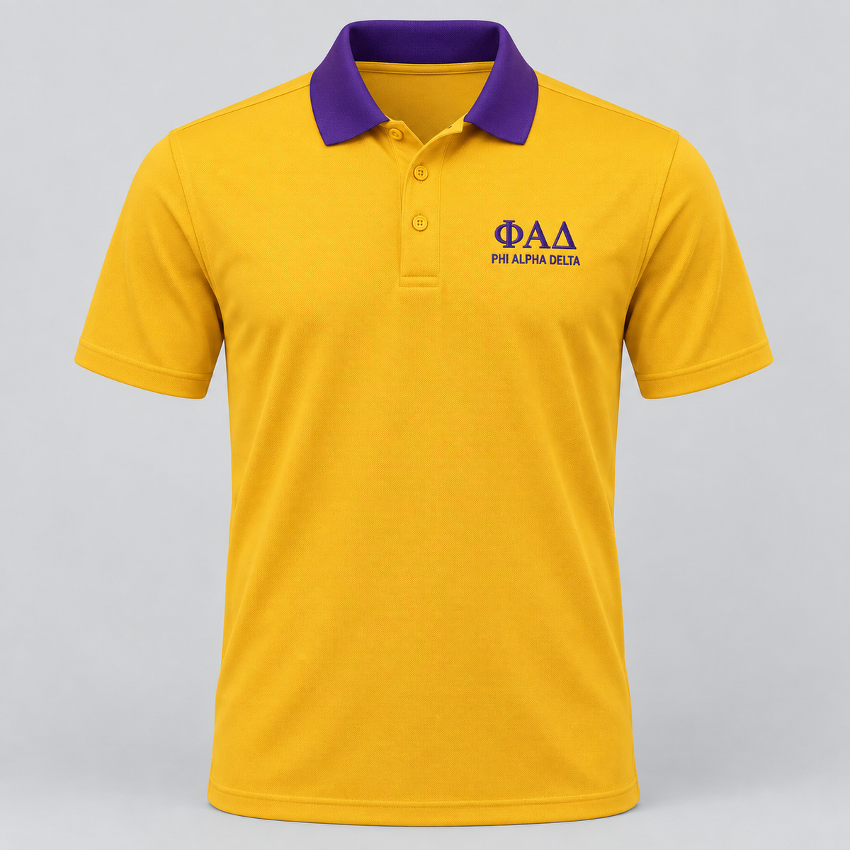 Phi Alpha Delta gold polo with purple contrast collar and left-chest embroidery