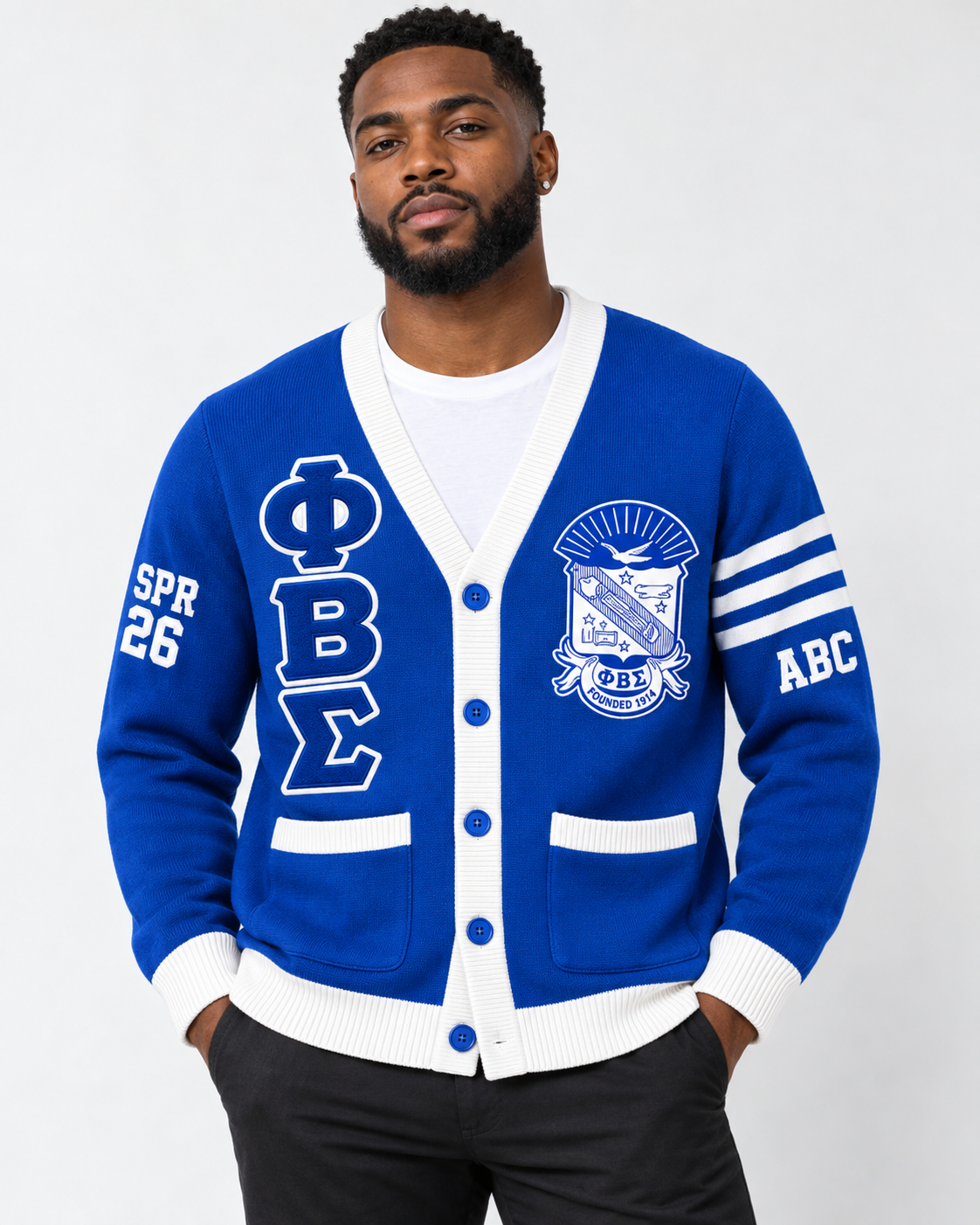Black male model wearing Phi Beta Sigma royal blue and white embroidered cardigan