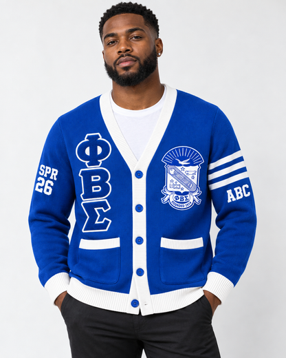 Black male model wearing Phi Beta Sigma royal blue and white embroidered cardigan