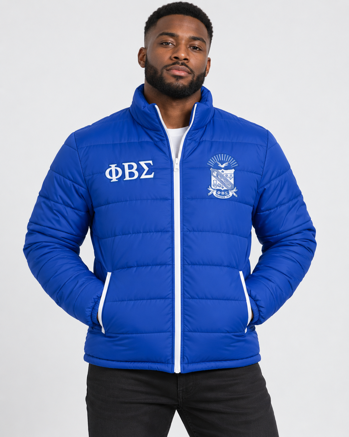 Phi Beta Sigma royal blue puffer jacket with white trim and custom embroidery on male model