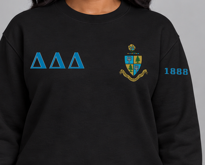 Delta Delta Delta premium embroidered black solid crewneck sweatshirt on model - chest embroidery close-up