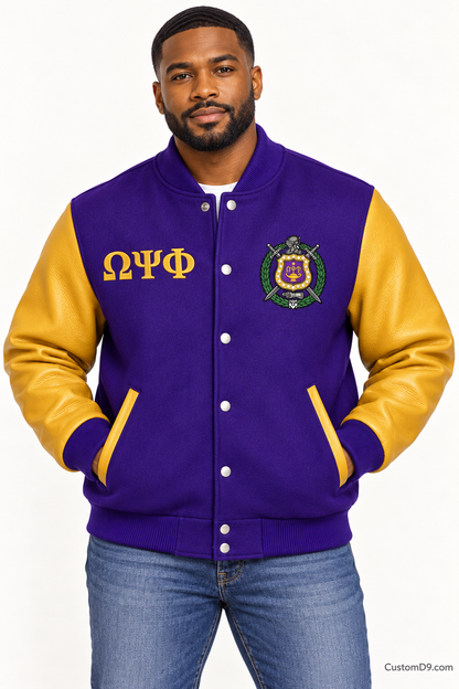 Black man modeling Omega Psi Phi premium contrast varsity jacket with royal purple body and old gold sleeves, front view.