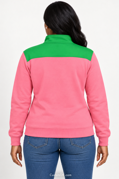 Black female model showing back of Alpha Kappa Alpha salmon pink quarter-zip with apple green shoulder panel