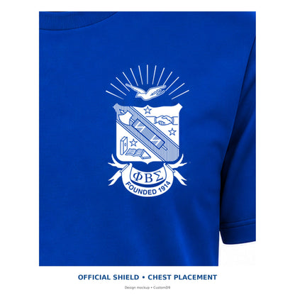 Digital artwork placement detail of the original Phi Beta Sigma shield on the royal blue T-shirt's left chest