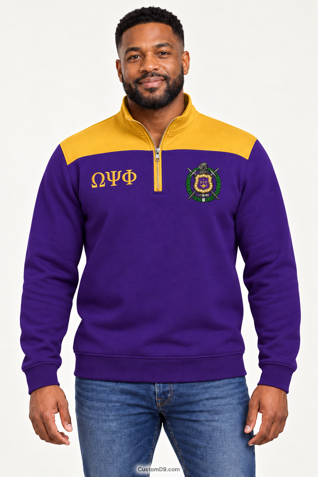 Black male model showing front of Omega Psi Phi royal purple quarter-zip with old gold shoulder panel