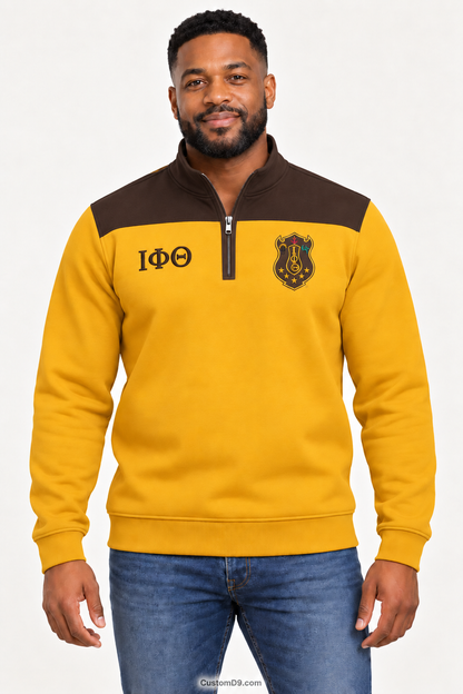 Black male model showing front of Iota Phi Theta gilded gold quarter-zip with charcoal brown shoulder panel