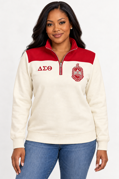 Black female model showing front of Delta Sigma Theta cream quarter-zip with crimson shoulder panel