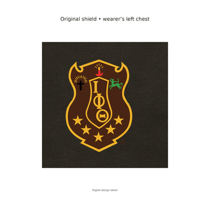 Digital design detail: the exact original Iota Phi Theta brand-kit shield, with its original colors, placed on the charcoal brown T-shirt