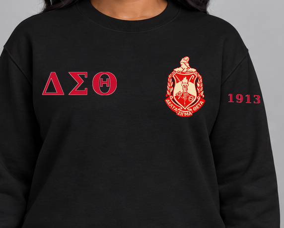 Delta Sigma Theta premium embroidered black solid crewneck sweatshirt on model - chest embroidery close-up