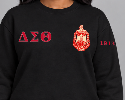 Delta Sigma Theta premium embroidered black solid crewneck sweatshirt on model - chest embroidery close-up