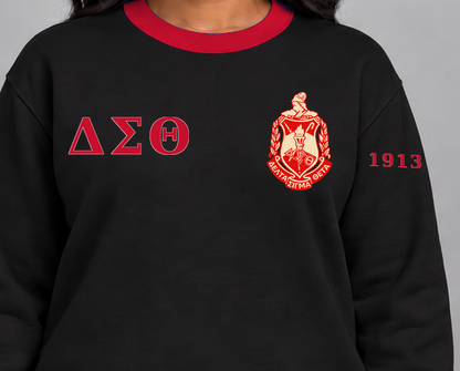 Delta Sigma Theta premium embroidered black solid contrast trim crewneck sweatshirt on model - chest embroidery close-up