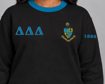 Delta Delta Delta premium embroidered black solid contrast trim crewneck sweatshirt on model - chest embroidery close-up