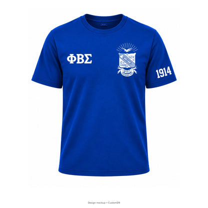 Design mockup: royal blue Phi Beta Sigma crewneck T-shirt with official left-chest shield, small white Greek letters and 1914 on wearer's left sleeve