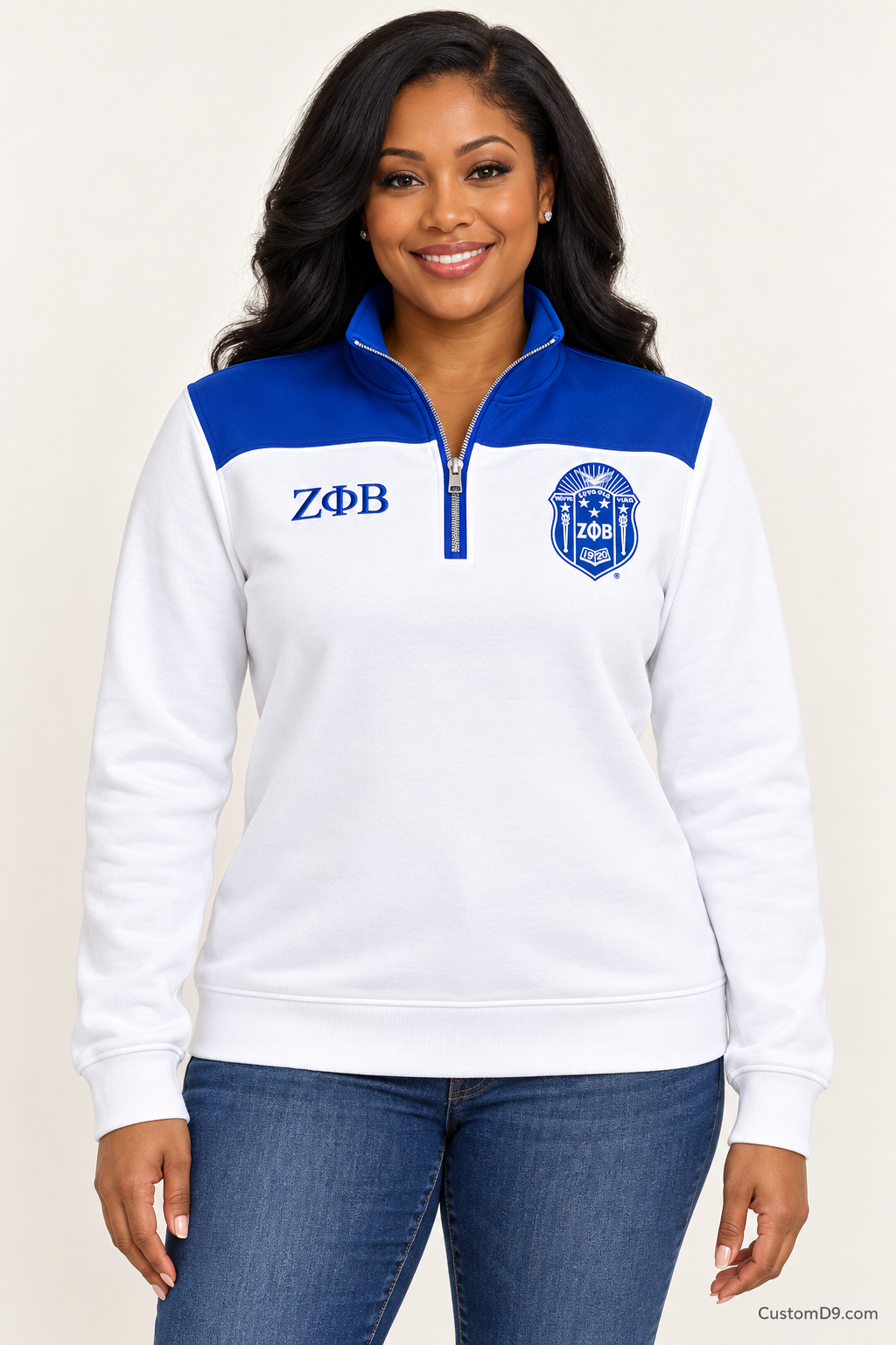 Black female model showing front of Zeta Phi Beta white quarter-zip with royal blue shoulder panel