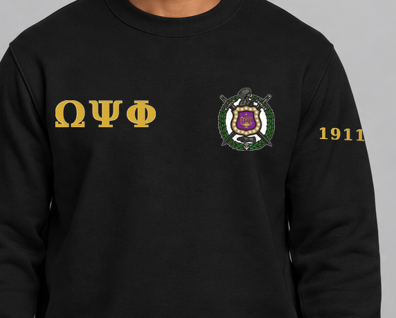 Omega Psi Phi premium embroidered black solid crewneck sweatshirt on model - chest embroidery close-up