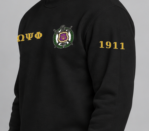 Omega Psi Phi premium embroidered black solid crewneck sweatshirt on model - founding year sleeve detail