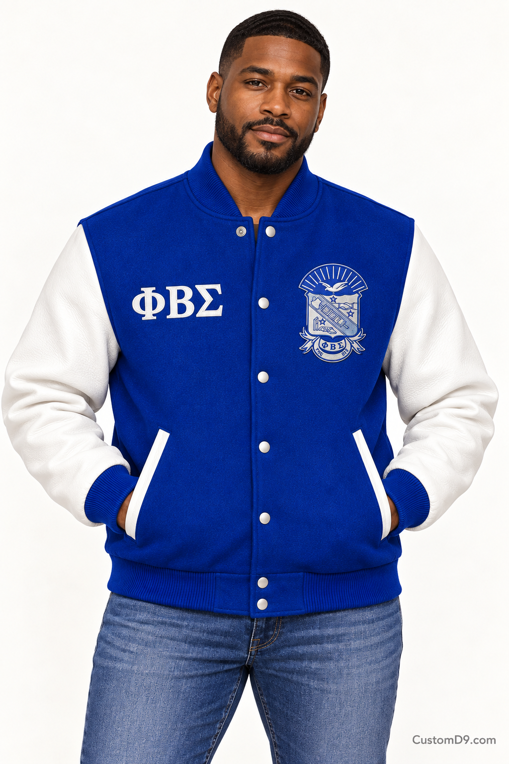 Black man modeling Phi Beta Sigma premium contrast varsity jacket with royal blue body and white sleeves, front view.