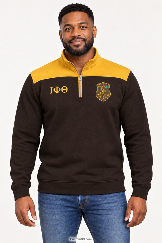 Black male model showing front of Iota Phi Theta charcoal brown quarter-zip with gilded gold shoulder panel