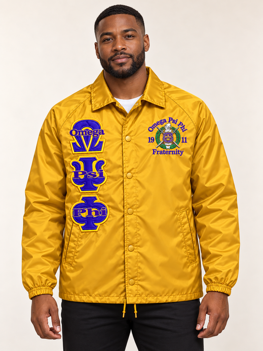 Black male model wearing a gold Omega Psi Phi custom embroidered coach line jacket with purple letters and crest