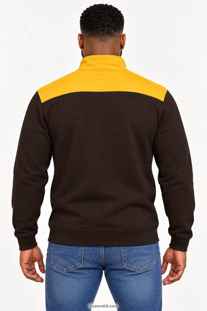 Black male model showing back of Iota Phi Theta charcoal brown quarter-zip with gilded gold shoulder panel