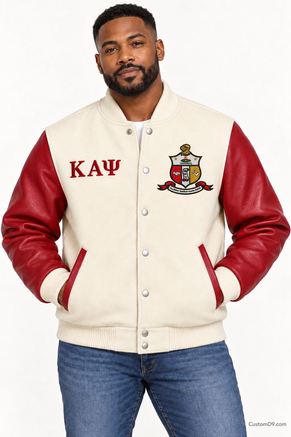 Black man modeling Kappa Alpha Psi premium contrast varsity jacket with cream body and crimson sleeves, front view.