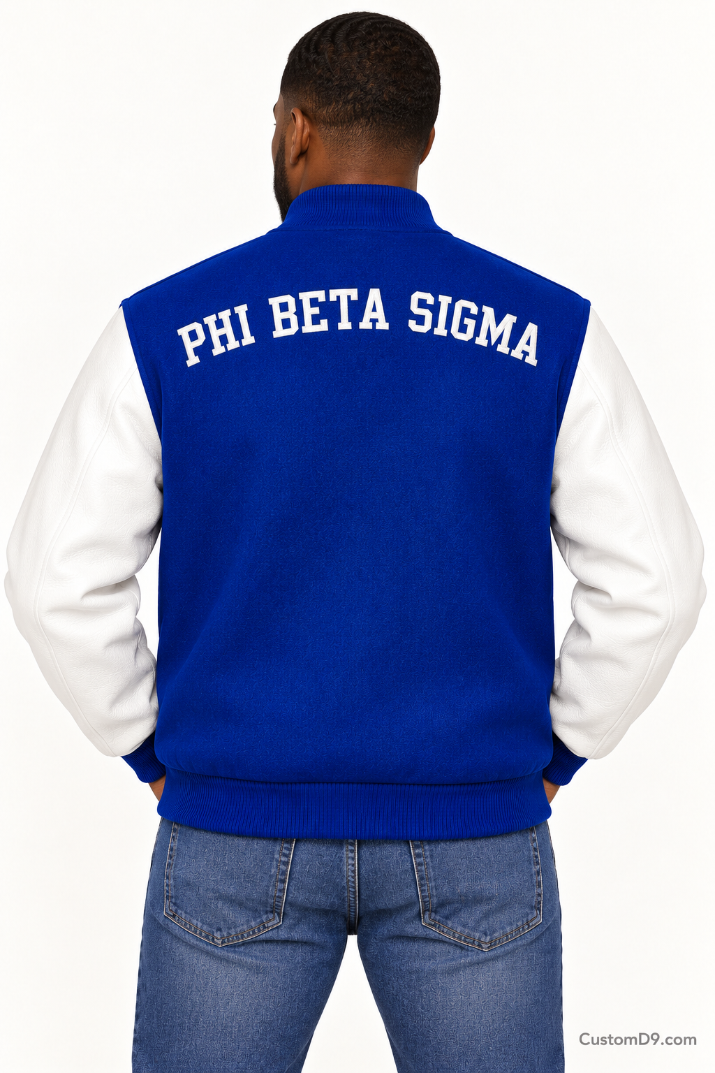 Black man modeling Phi Beta Sigma premium contrast varsity jacket with royal blue body and white sleeves, back view.