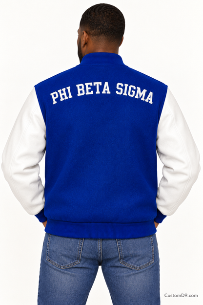 Black man modeling Phi Beta Sigma premium contrast varsity jacket with royal blue body and white sleeves, back view.