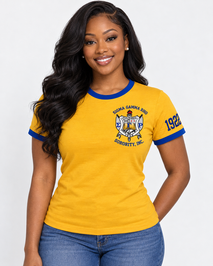 Model wearing a gold Sigma Gamma Rho ringer T-shirt with royal blue trim, chest crest and 1922 sleeve design