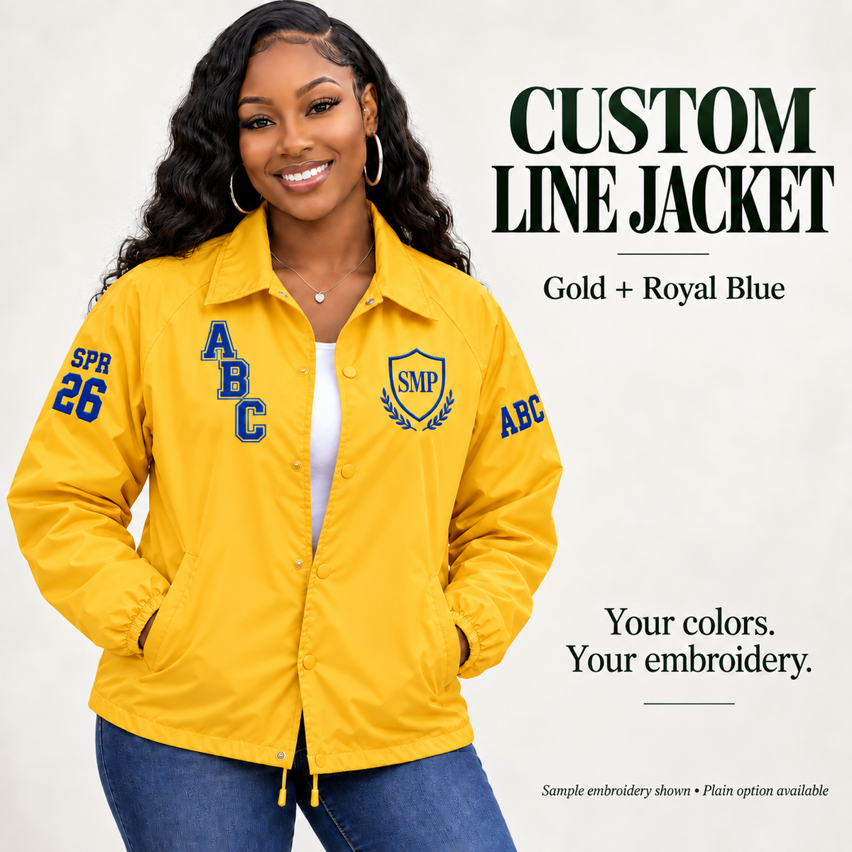 Gold nylon snap-front line jacket with royal blue sample embroidery on a female model