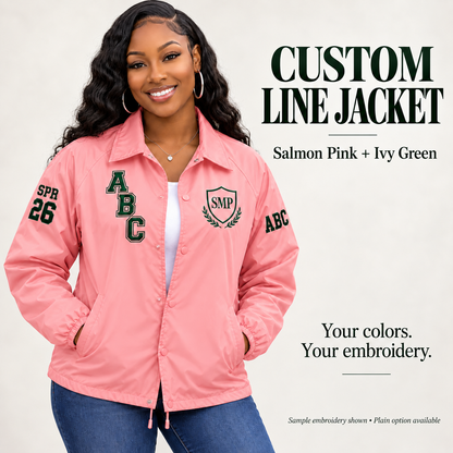 Salmon pink nylon snap-front line jacket with green sample embroidery on a female model