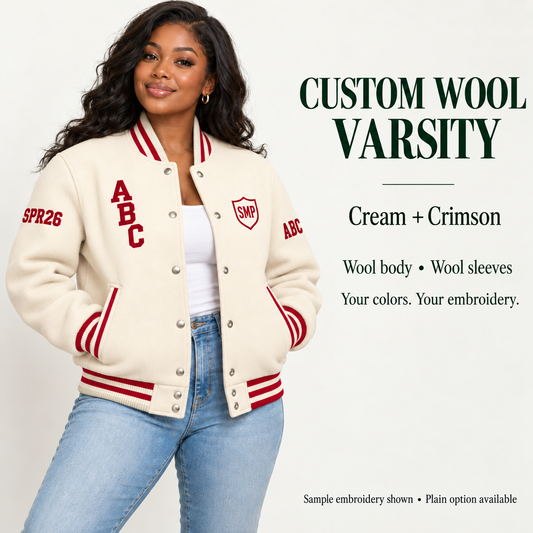 Woman wearing Cream wool body and wool sleeve varsity jacket with Crimson sample embroidery