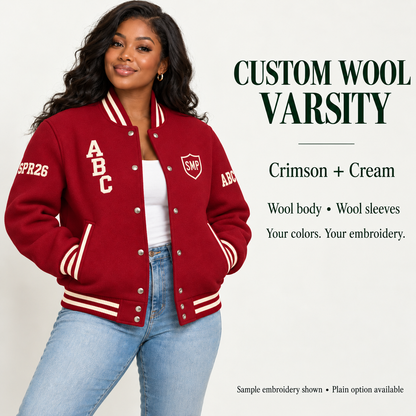 Woman wearing Crimson wool body and wool sleeve varsity jacket with Cream sample embroidery