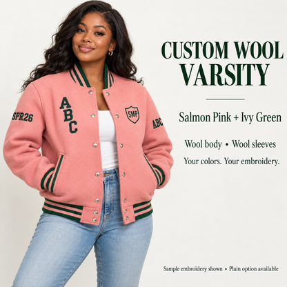 Woman wearing Salmon Pink wool body and wool sleeve varsity jacket with Ivy Green sample embroidery