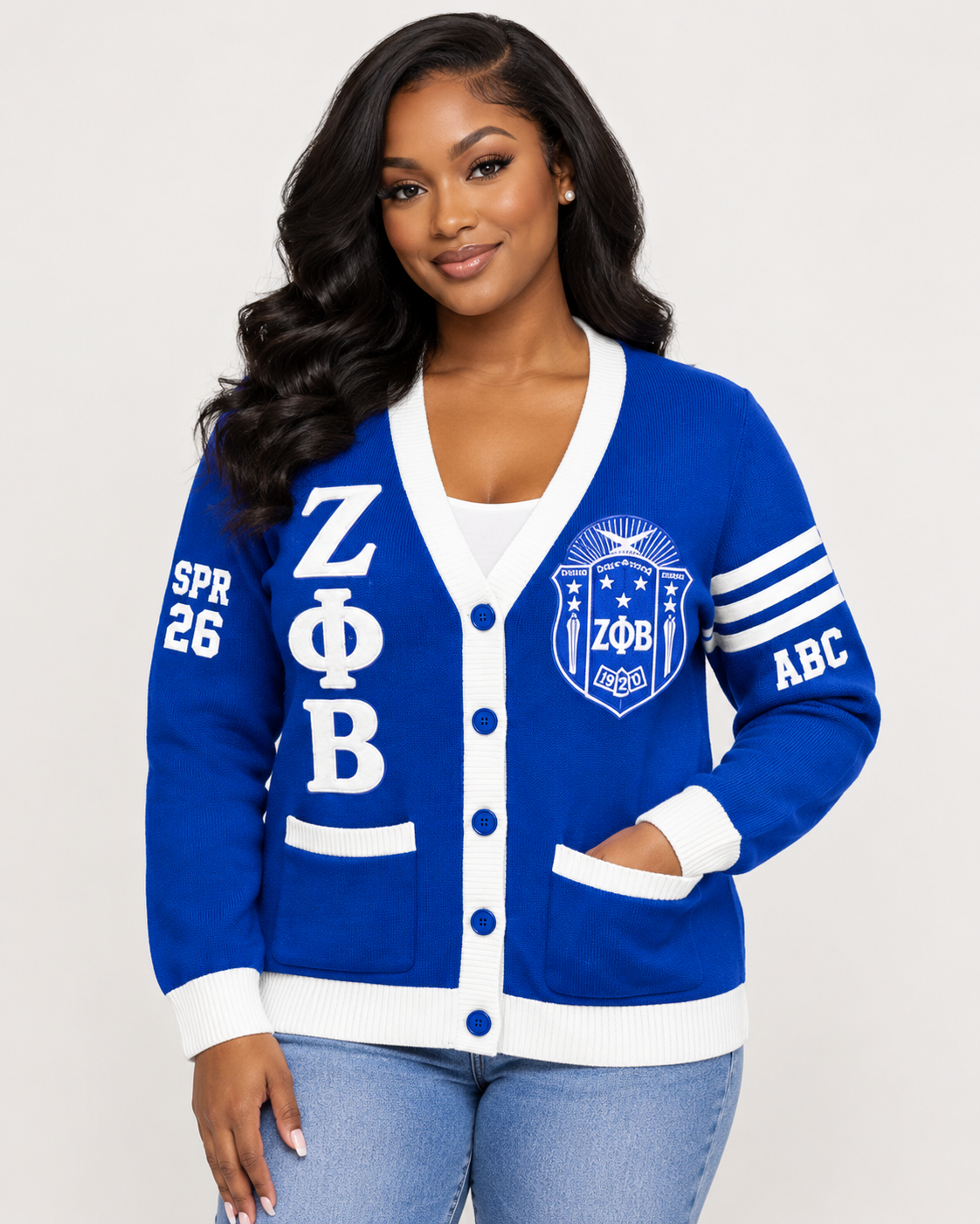 Black female model wearing Zeta Phi Beta royal blue and white embroidered cardigan
