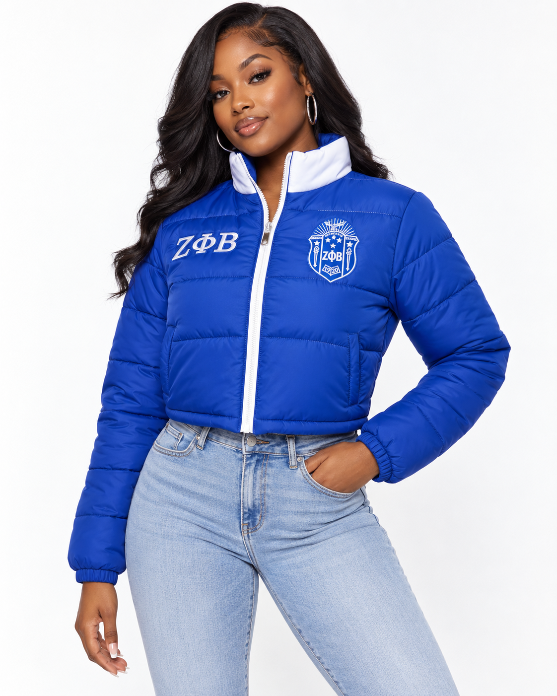 Zeta Phi Beta royal blue cropped puffer jacket with white trim and custom embroidery on female model